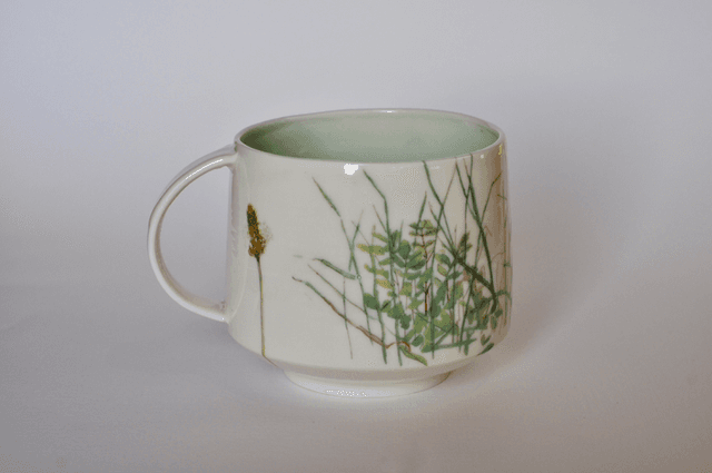 Porcelain cup with illustrated scene